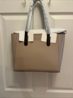 kate spade warm beige tote with black handles, zipper